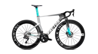 Road bike full view with black wheels, silver frame, and teal seatpost