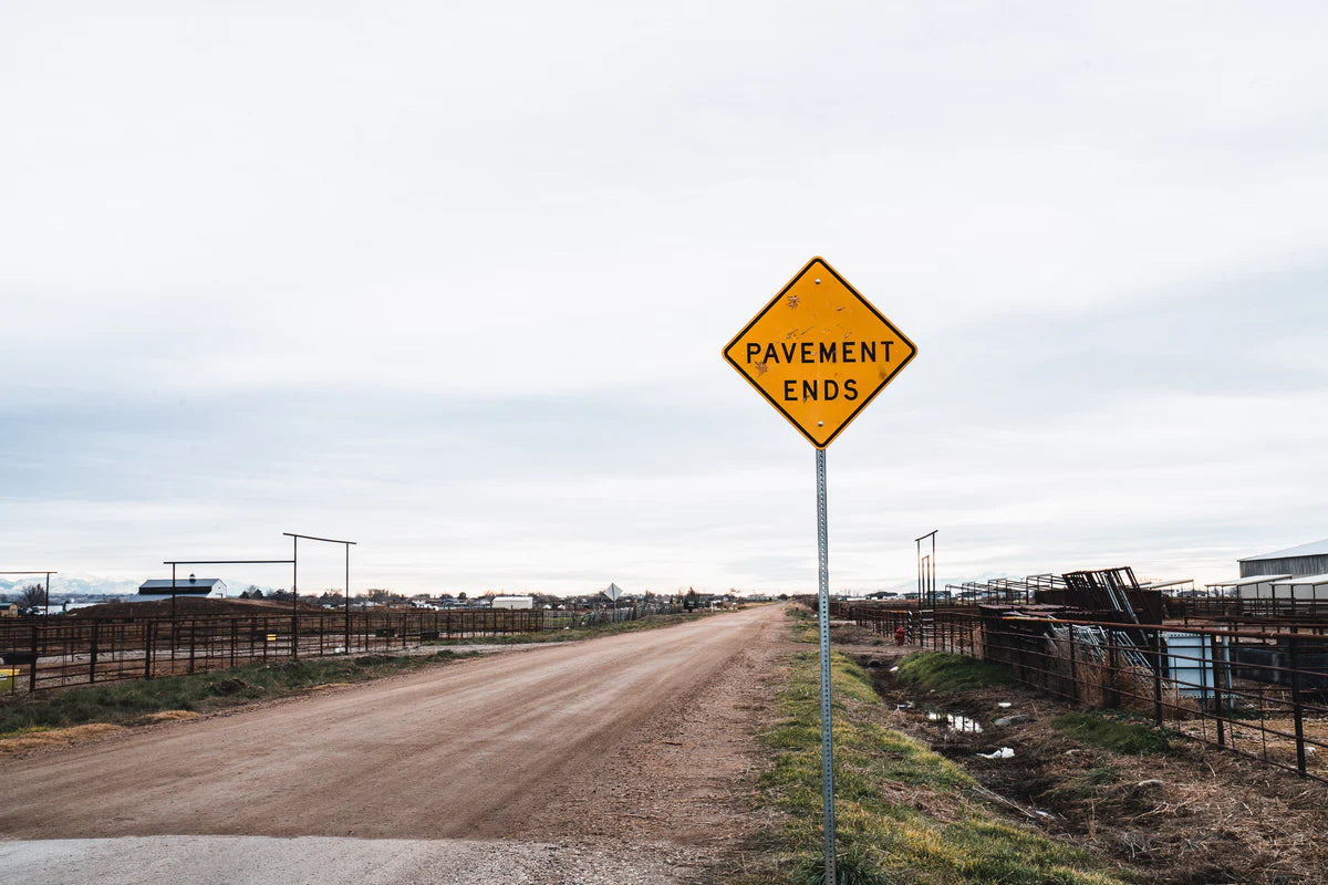 Roadside pavement ends sign with yellow diamond warning marker