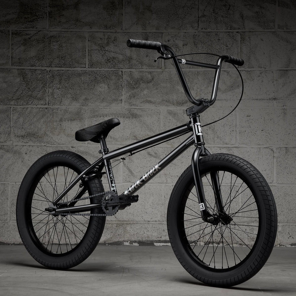 Black BMX bike with front handbrake and knobby tires, side view