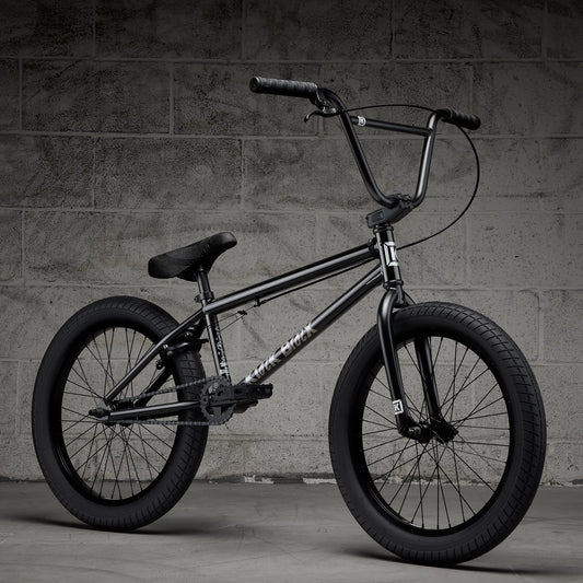 Black BMX bike with front handbrake and knobby tires, side view