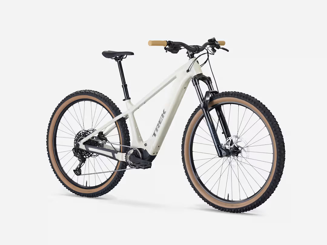 Buff beige electric mountain bike with handlebars, saddle, and front suspension