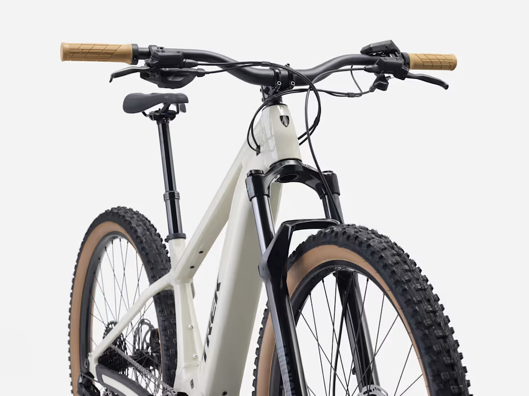 Buff beige electric mountain bike with front suspension and wide knobby tires